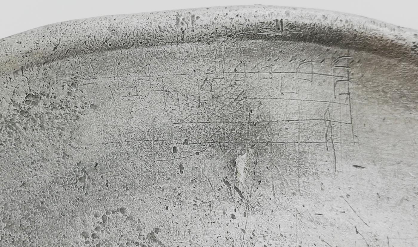 Figuur 8: Detail ingekraste muzieknotatie op het tinnen bord (Foto Abdijmuseum inv. nr. 040307)